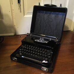 Typewriter shown with case.
